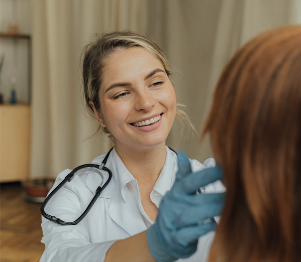 Clinician giving patient an exam Clinician giving patient an exam